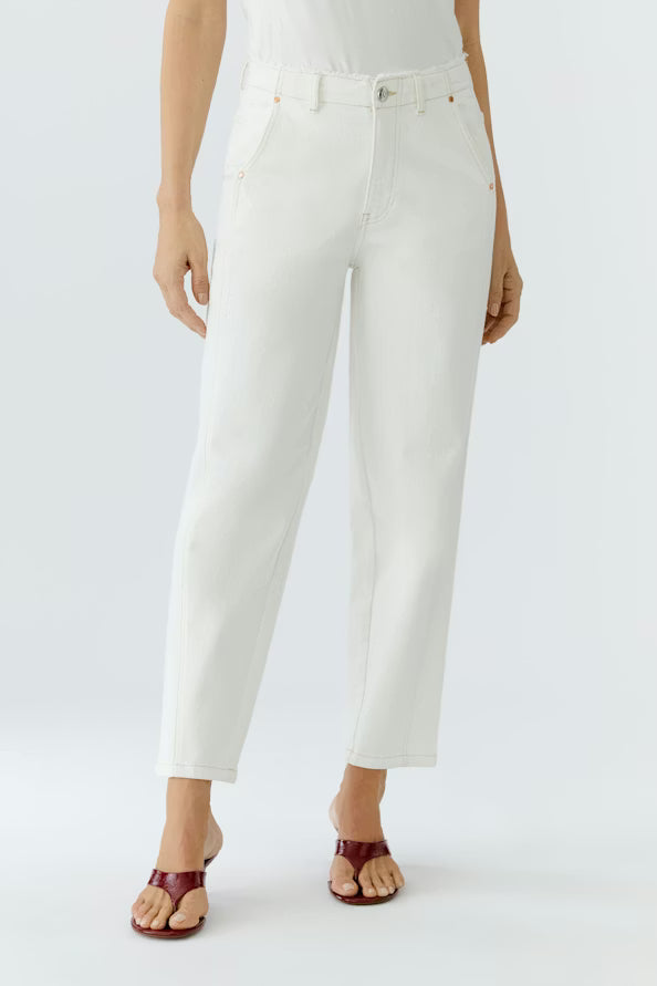 Person wearing white pants on a plain background