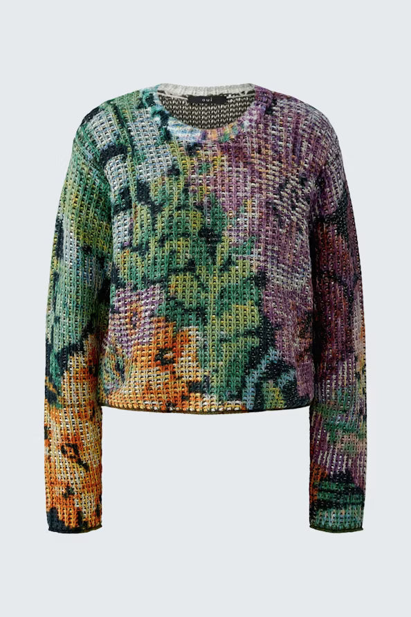 A cropped, long-sleeve knit sweater with a vibrant, multicolored abstract pattern featuring green, purple, orange, and yellow tones, displayed on a light gray background.