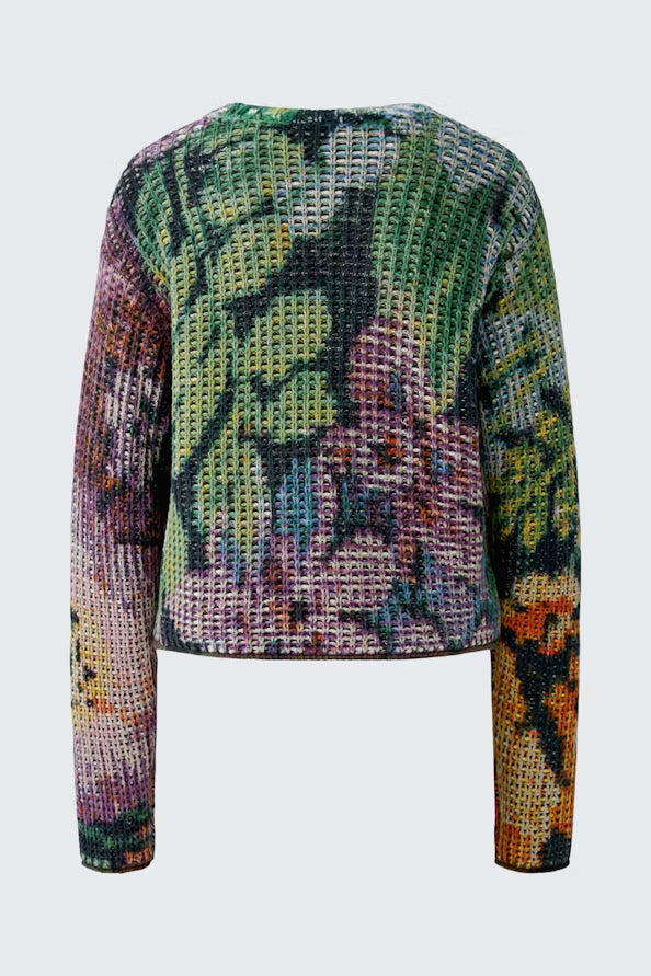A cropped, long-sleeve knit sweater with a vibrant, multicolored abstract pattern featuring green, purple, pink, orange, and yellow tones, shown against a light gray background.