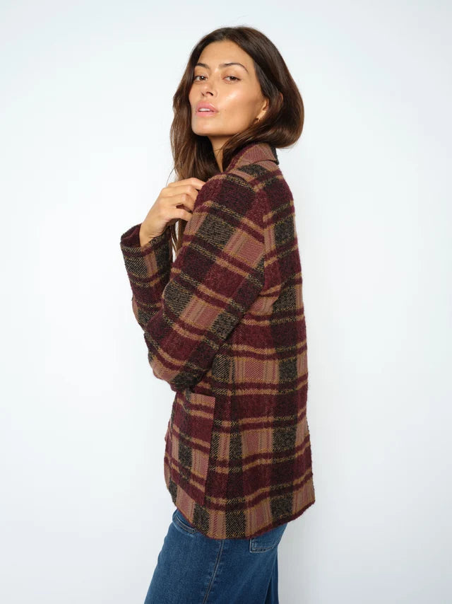 Woman wearing a plaid shirt with a white background