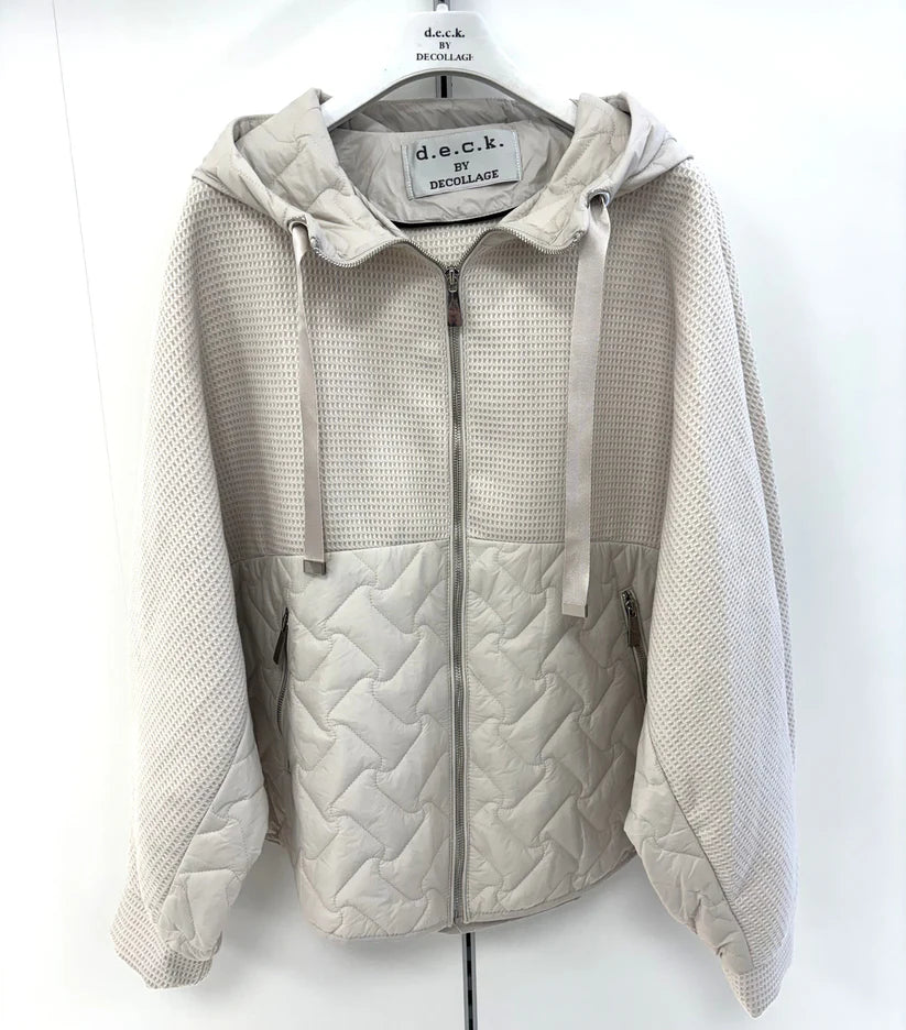 Light gray quilted jacket on a hanger with a white background