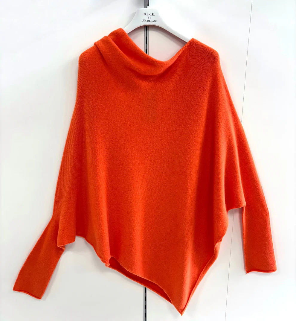 Orange sweater on a hanger against a white background