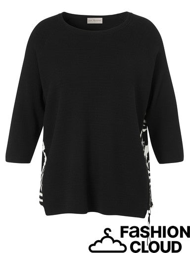 A black three-quarter sleeve knit top with a crew neck, shown against a plain white background. The bottom hem has a side slit with a black and white patterned lining, and a 'FASHION CLOUD' watermark is visible in the bottom right corner.