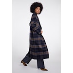 A model wearing a long navy and black plaid coat with matching wide-leg trousers, shown from a side-back angle against a plain white studio background.