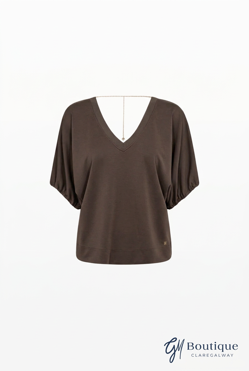 A dark brown short-sleeve V-neck top displayed on a white dress form against a white background, with a 'GM Boutique Claregalway' logo in the bottom right corner.