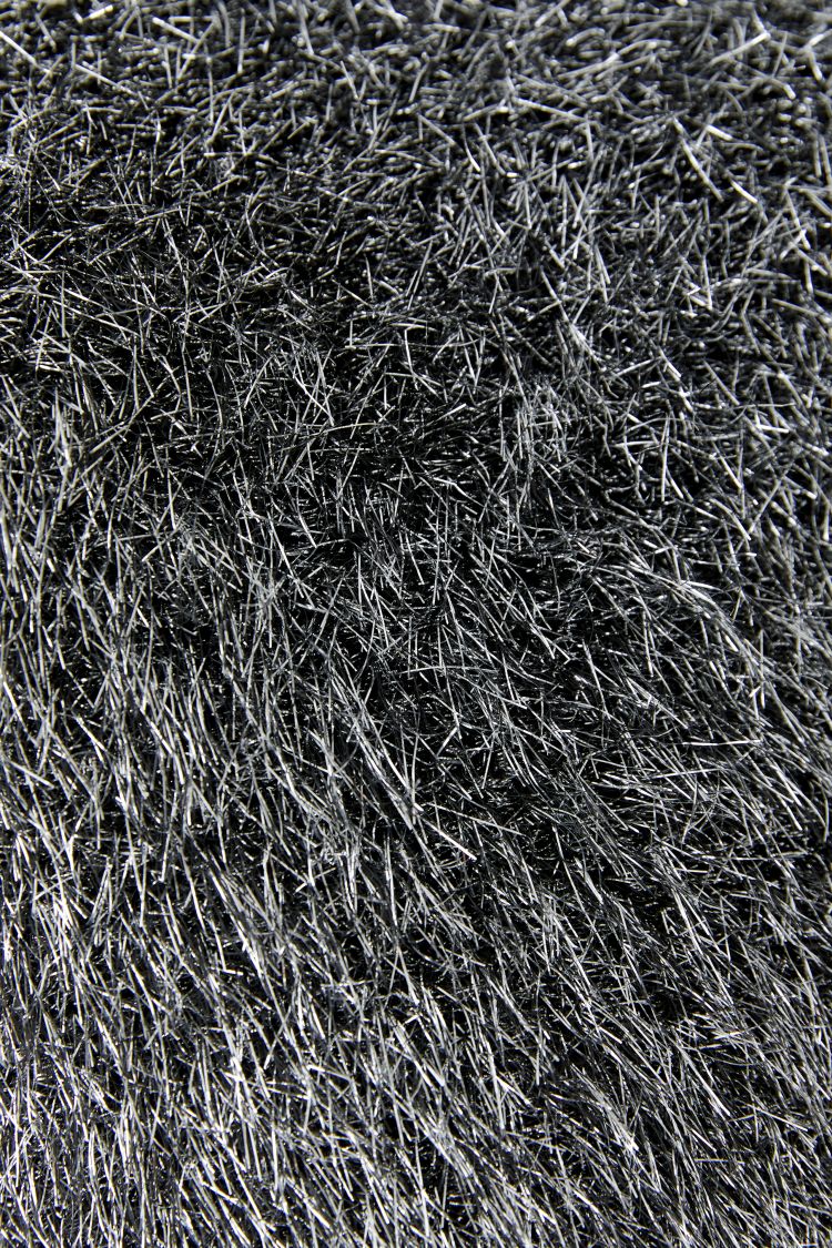 A close-up texture shot of a black and gray shaggy pile fabric or faux fur material from the Metallic Silver Knit Jumper by Oui | GM Boutique | Galway
