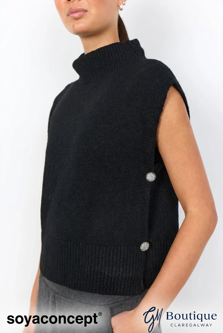 A sleeveless black knit mock neck vest with decorative silver buttons on the side, worn by a model. The image features 'soyaconcept' and 'GM Boutique CLAREGALWAY' watermarks at the bottom.