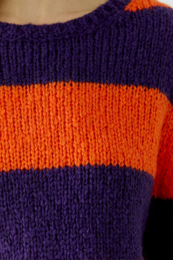 Close-up of a sweater with purple and orange stripes