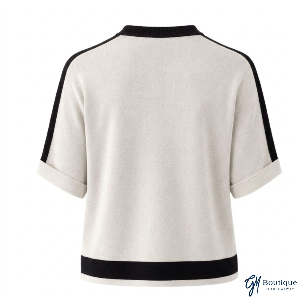 Back view of Tuzzi ivory pullover with black contrast trim and turned-up short sleeves.
