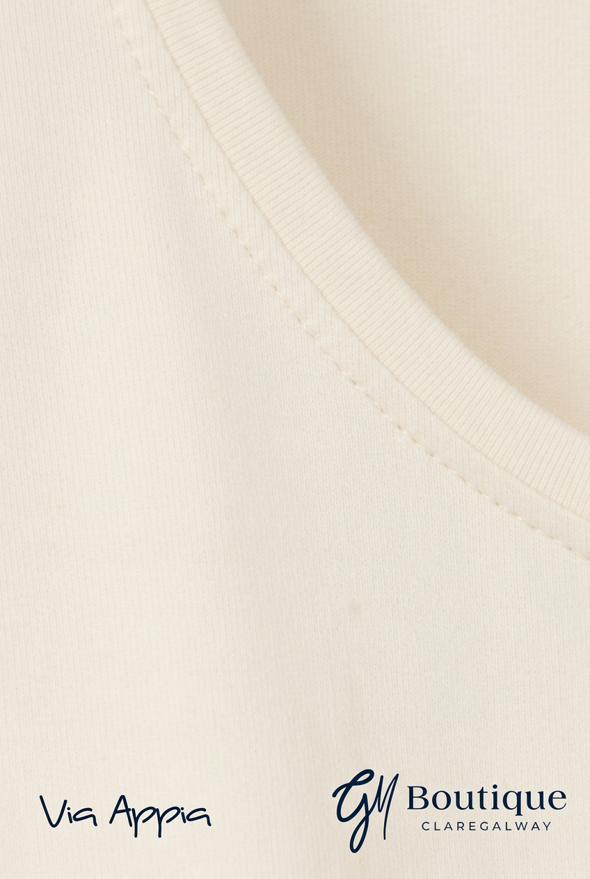 AI-edited cream fabric and neckline detail preview with Via Appia and GM Boutique logos