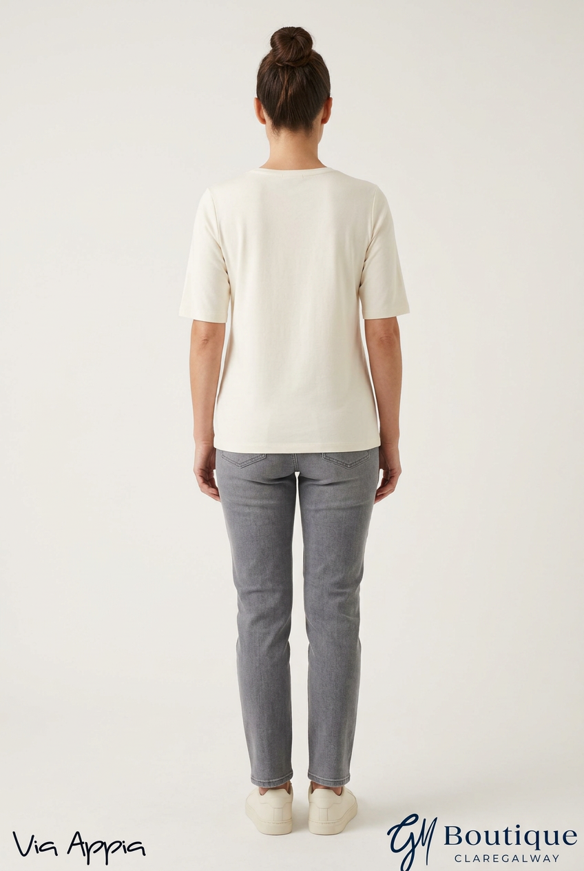 AI styling preview of Via Appia cream T-shirt on a model, plain back view, with both logos