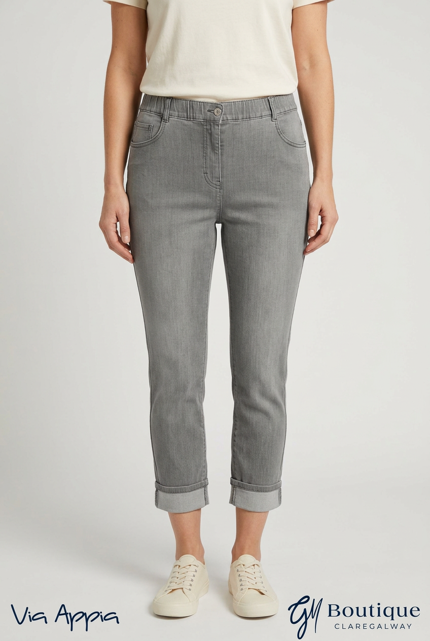 AI styling preview of Via Appia grey turn-up jeans on a model, front view, with Via Appia and GM Boutique logos