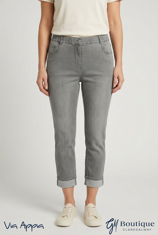 AI styling preview of Via Appia grey turn-up jeans on a model, front view, with Via Appia and GM Boutique logos
