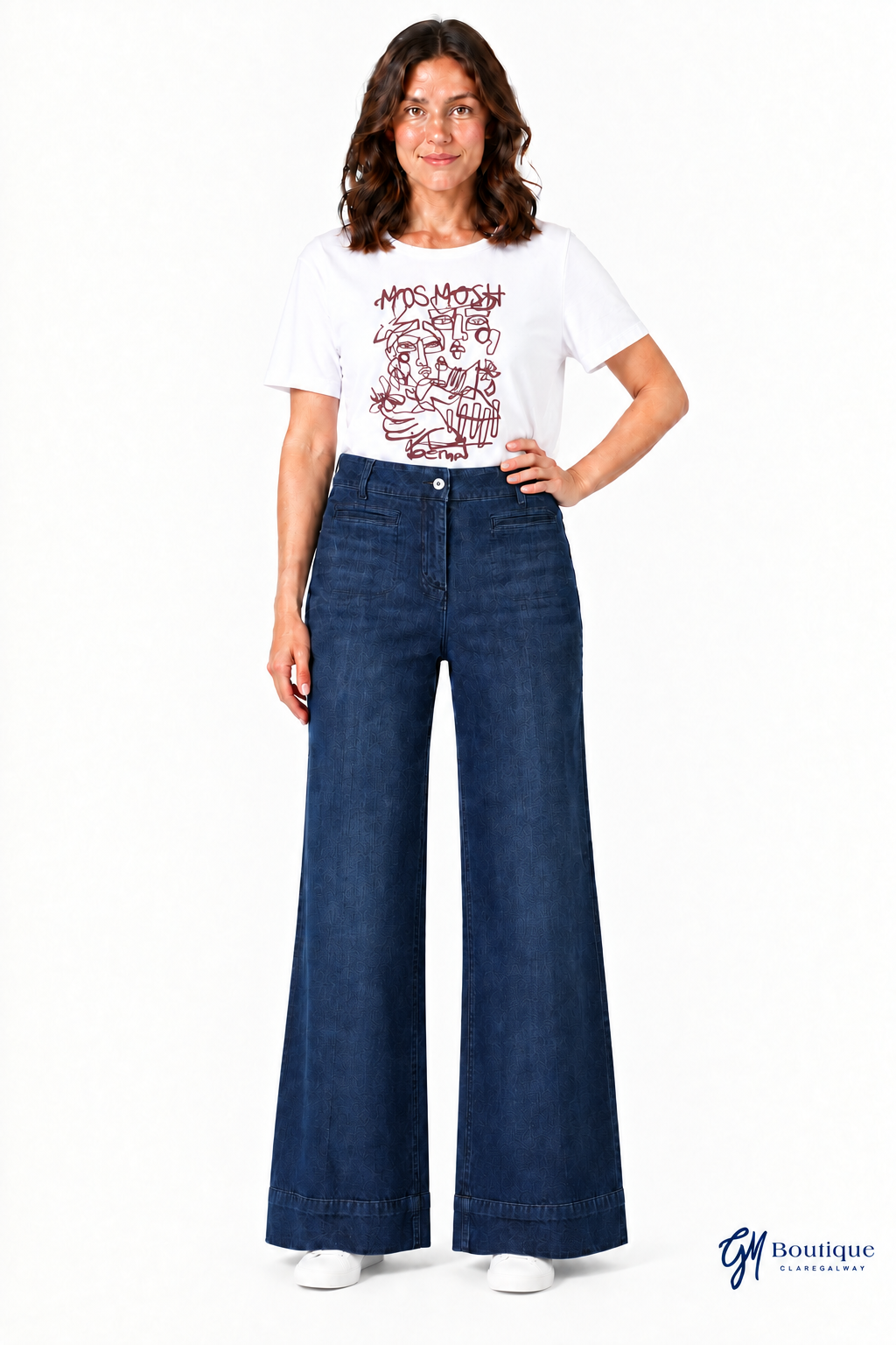 White graphic T-shirt and flat trainers with near-floor jean hems